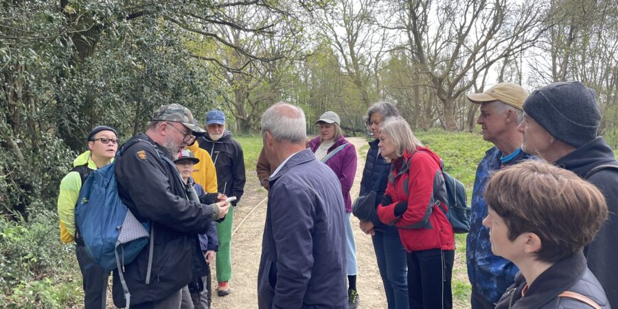 Michael Blencowe showing a group of people a leaf, all look very interested.