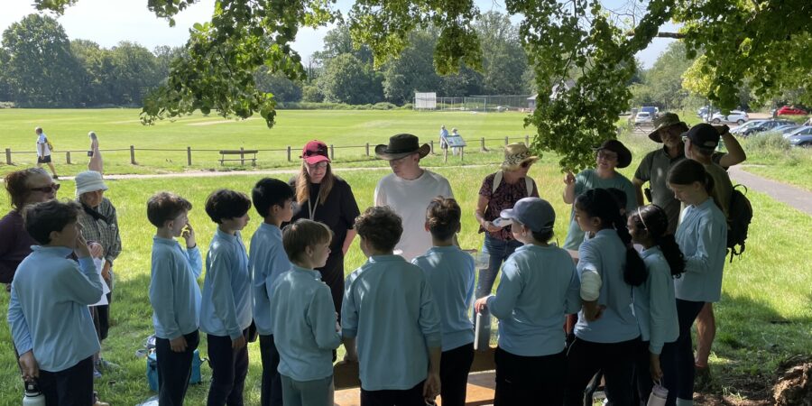 Group of children and adults taking part in a butterfly workshop on the Commons